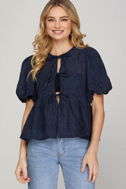 IN THE FLOW NAVY EYELET BOW FRONT PEPLUM TOP